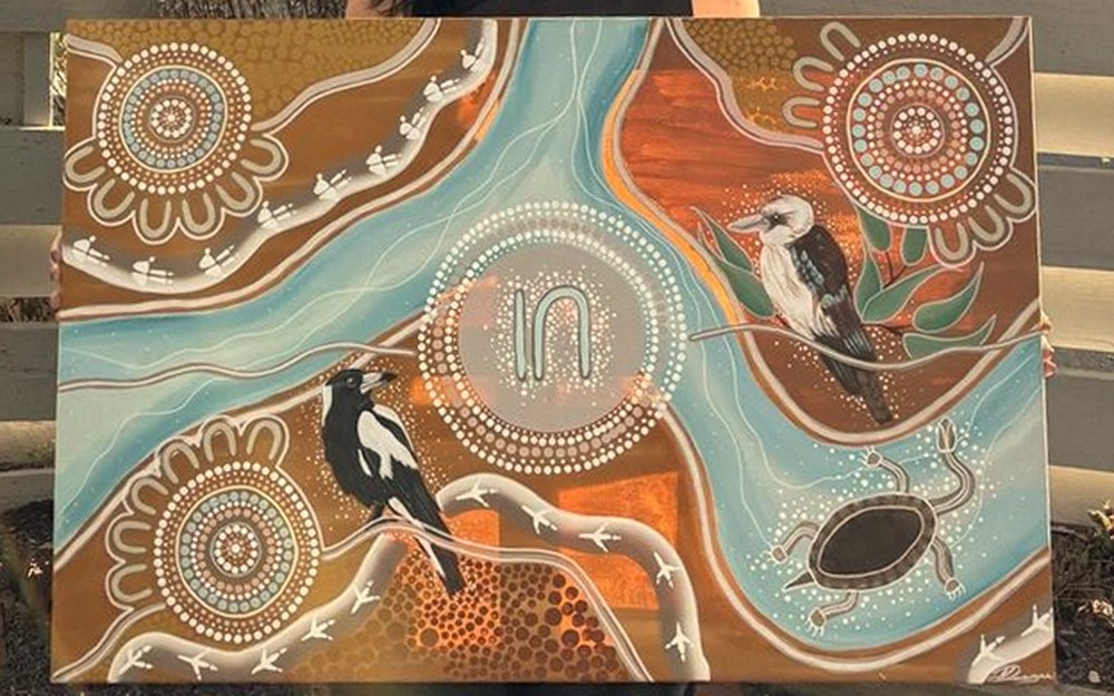 A commissioned First Nations painting by Kayla Deegan of Yuuruu Creations: meeting-place circles, a kookaburra, a magpie and a turtle, with journey paths in ochre, terracotta and teal.